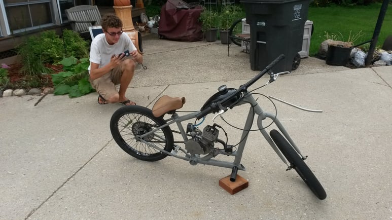 Mitchell with a motorized bike he built.